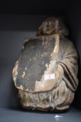 A 19th century carved wood crest bearer having indistinct coats painted to plaque.