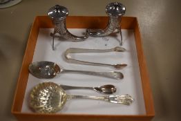 A pair of white metal Norwegian salt and pepper pots of unusual shape, a pair of sugar nips and