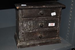 A vintage set of three drawers made from cigar boxes.