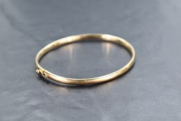 A 9ct gold bangle of plain form having concealed clasp, approx 5g