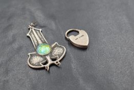 An Edwardian silver pendant by Charles Horner having iridescent enamelled centre, missing drop