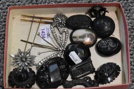 A selection of Victorian black mourning brooches and three hair slides