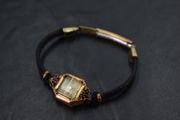 A lady's 9ct rose rose gold wrist watch having Arabic numeral dial to square face in a gold case