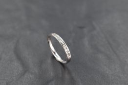 A ten stone channel set diamond chip eternity ring on an 18ct white gold loop, size L & approx 2.1g