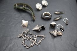Five pairs of white metal/silver stud earrings of stylised form, a similar ring and a white metal