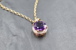 A heat treated amethyst pendant in a 9ct gold mount on a gold belcher chain, approx 17' & 9g