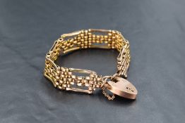 A 9ct gold fancy link gate bracelet with padlock clasp, approx 17.7g