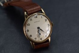 A 1960's gent's gold watch by Garrard having an Arabic numeral dial with subsidiary seconds to