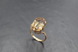 An oversized smoky quartz solitaire ring in a six claw raised mount on a 9ct gold loop, size T &