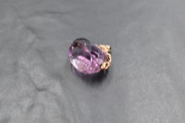 An amethyst seal fob having gold chain fitting and carved initials, marks worn