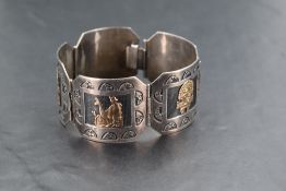 A Peruvian silver and yellow metal bracelet comprising of five articulated panels each bearing a