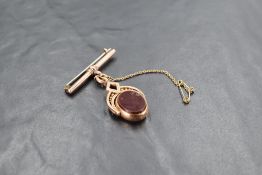 A 9ct gold pendant swivel fob brooch, the oval fob with bloodstone and carnelian matrixes, pivoted