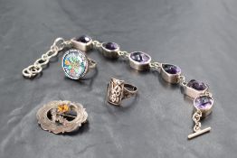 A white metal and purple stone bracelet, having shaped and facet-cut links, and T bar and loop