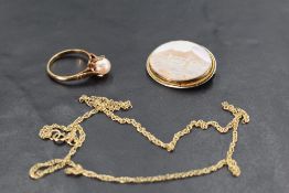 A small conch shell scenic cameo brooch in white metal mount, a fine 9ct gold chain and a cultured