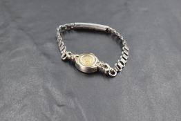 A ladies 9ct white gold cocktail watch by EMKA having baton numeral dial to small face in a white