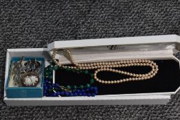 A malachite bead necklace, having slightly graduating beads interspersed by small glass beads,