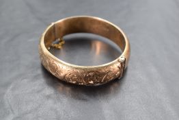 A silver gilt bracelet, of hinged oval form with half engraving, marks for Chester 1953, maker