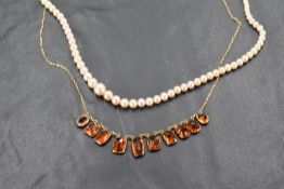 A graduating pearl bead necklace, having an ovoid barrel clasp marked 9ct, 42cm over all, sold along