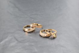 Three 9ct gold rings having clear paste stones and another stamped 10K having four pale coloured