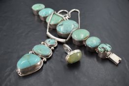 Three pieces of silver and turquoise jewellery of stylised form including seven panel oversized