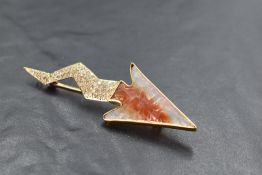 An 18ct gold agate & diamond brooch in the form of a lightning bolt having a rough cut orange
