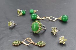 Five pairs of stud earrings and a dress ring all having green stones including jade style, mounts