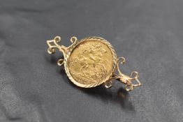 A gold half sovereign dated 1911 in a 9ct gold removable brooch mount, approx 6.3g