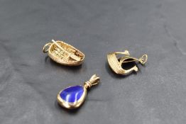 A 9ct gold charm in the form of a Welsh Coracle, a 14ct gold Norwegian charm in the form of a Viking