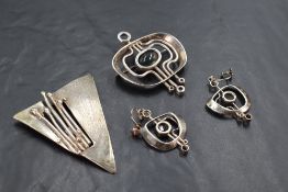 A 1980's silver brooch with matching earrings of modernist form having central moss agate panels,