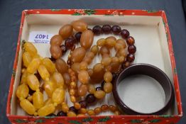 Four amber style necklaces and a bangle