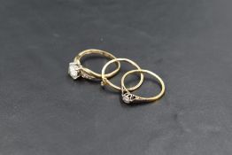 A diamond solitaire ring, approx 0.05ct in an illusionary mount on an 18ct gold loop (AF) a Cubic