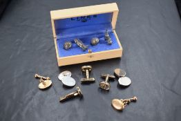 A cased set of golfing interest cuff-links, formed as gold bag and clubs and ball, unmarked,