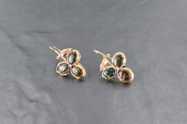 A pair of yellow metal and black opal earrings, of foliate form, each with three inset black opal
