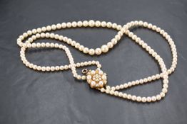 A double strand cultured pearl necklace, the two strands with graduating pearls and finishing with a