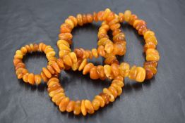 A butterscotch amber bead necklace, comprising numerous graduating asymmetrical beads, 34cm, 47.