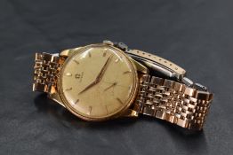 A gents Omega wrist watch having baton numeral dial and subsidiary seconds to champagne coloured