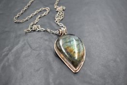 A 925 grade white metal and labradorite pendant, of inverted tear drop form with scrolled suspension