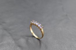A five stone tanzanite ring on a 9ct gold loop, size Q & approx 2g