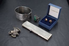 Five pieces of HM silver & white metal including a hinged bangle having engraved scroll