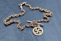 A 9ct rose gold watch chain with T bar and swastika charm, approx 15' & 34.4g