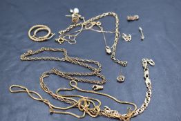 A selection of broken 9ct gold and yellow metal jewellery, presumed gold, including chains and