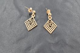 A pair of yellow metal earrings, of Charles Rennie Mackintosh design, unmarked but butterfly