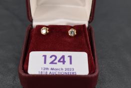 A pair of 18ct gold and diamond solitaire earrings, the brilliant cut stones totalling 0.25cts