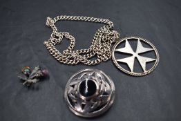Three pieces of silver jewellery including a Scottish thistle brooch, knot brooch with jet centre