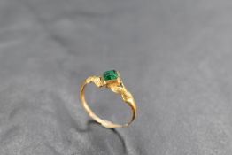 A 17th Century Jacobean gold and emerald fede ring having central emerald in collared mount with