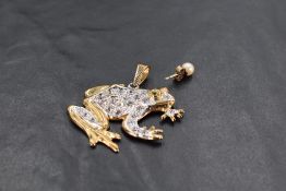 A 9ct gold pendant modelled as a frog with paste stone decoration, approx 12.2g(no chain) and a