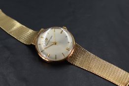 A gents 9ct gold dress watch by Girard Perragaux having a baton numeral dial with gold hands to