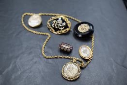 A selection of Victorian and later jewellery including mourning brooches, glass locket on rolled