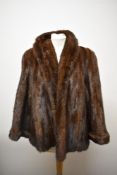 A dark brown mink jacket having 'M W' monogrammed to lining,wide sleeves and turn-ups to cuffs.