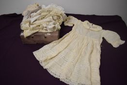 A selection of babies and children's clothing, including silk dresses, some beautiful detailed